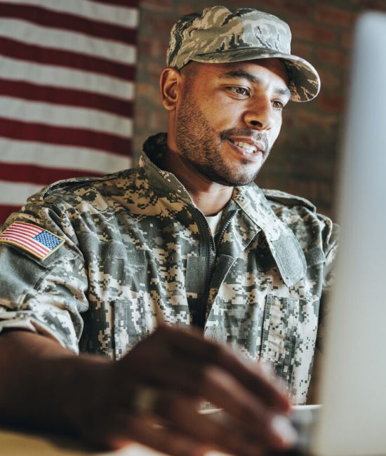 young soldier taking an ASVAB test on a laptop