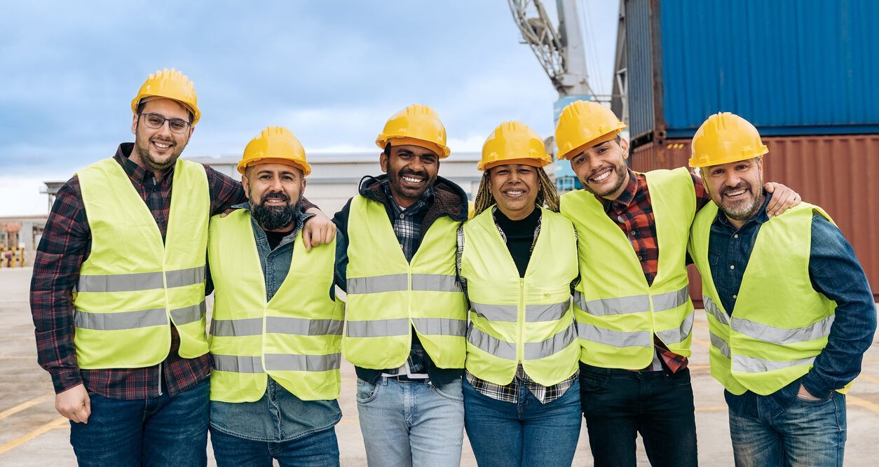 Multiracial construction workers standing side by side